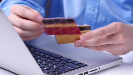 Man making online purchases with credit cards