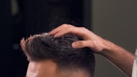 closeup-of-barber-sprinkles-with-powdered-sugar-for-styling