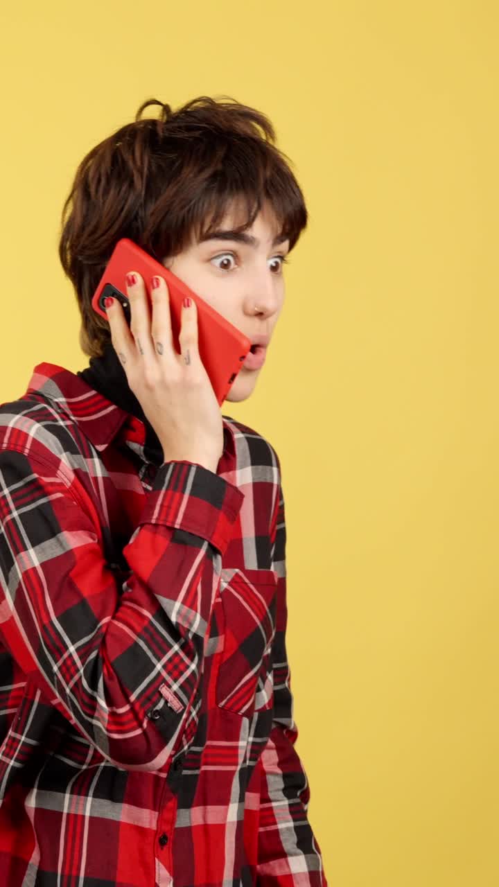 Young Woman with Shocked Expression on a Phone Call