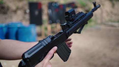 close up of person load combat bullet into weapon pressure chamber, czechia