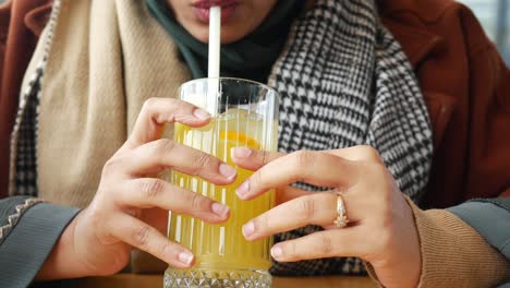 a woman enjoying a refreshing glass of lemonade