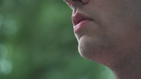 close up of male model smoking vaporizer outside slow motion