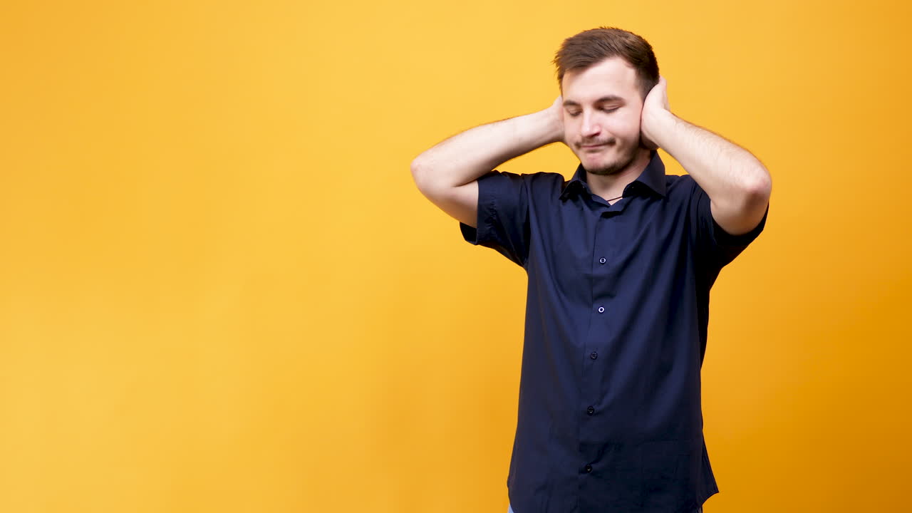 Man covering ears to avoid noise