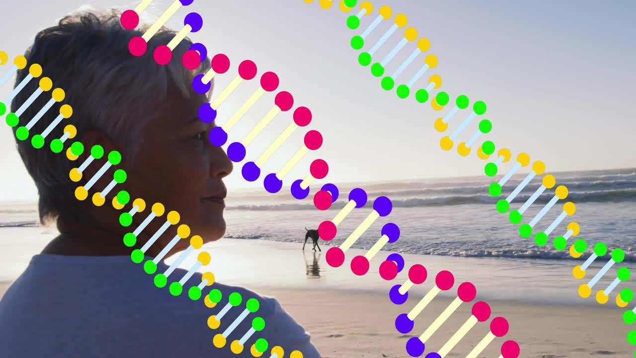 Elderly person enjoying beach with colorful DNA strand animation overlay