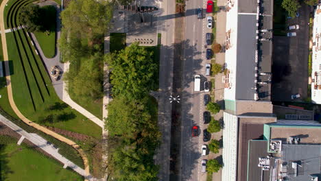 top down aerial - road in the middle of the city between buildings and trees - urban park and walking paths - urban architecture and relaxation zones in the city center of gdynia