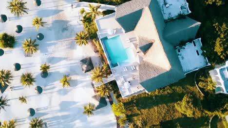 great rotation 360 drone shot from above a luxury villa with a fantastic pool and long shadows