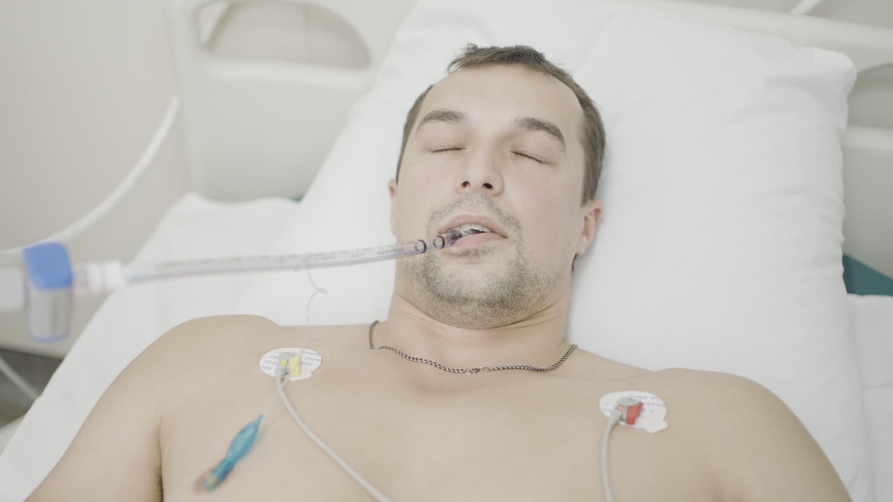 Man in Hospital Bed with Medical Equipment