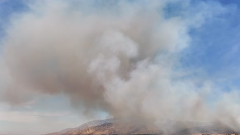 large-plumes-of-dark-and-white-wildfire-smoke-in-california-AERIAL-STATIC