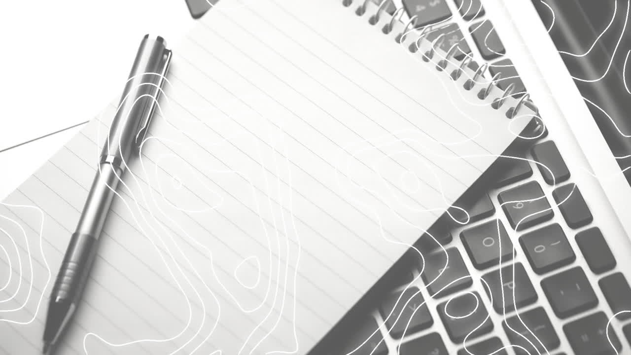 Animation of white lines moving over laptop, notebook and pen on desk