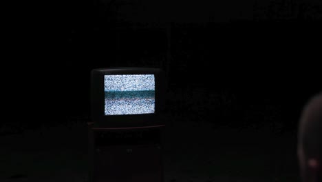 vintage tv with static and person