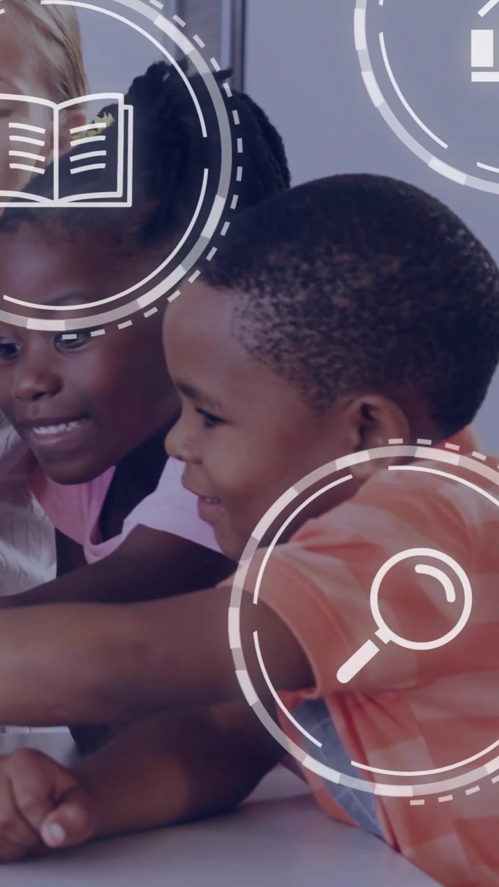 Vertical video: Peers leaning round table, viewing child showing device, HUD icons tracking lesson