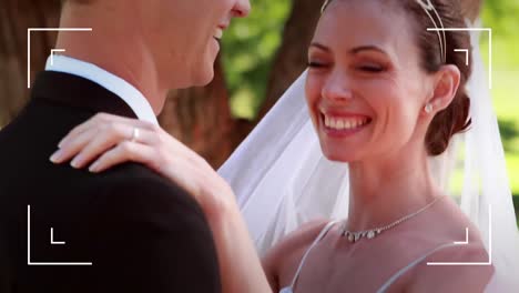 animation of camera interface over happy bride and groom on wedding day