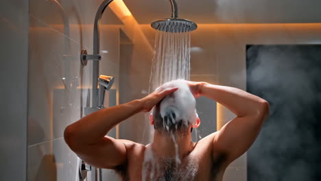 man taking a shower in a modern bathroom