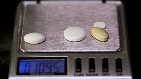 pills on a digital scale