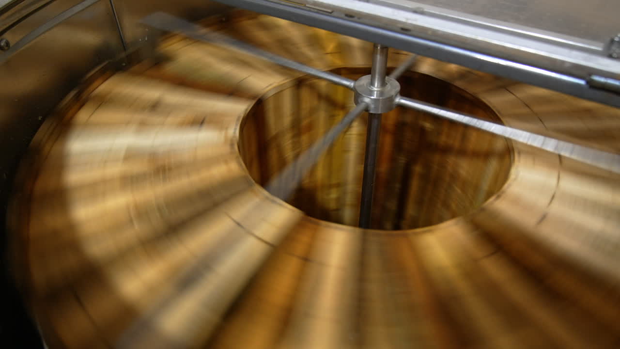 Honey extracting machine working. Honey frames are rotated in the apparatus to get fresh organic product. Close up.