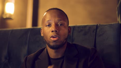 professional male talking to camera assertively using hand gestures on videocall