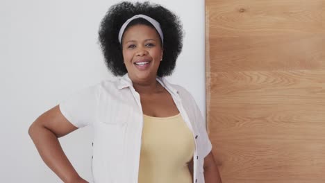 portrait of happy african american plus size woman smiling, unaltered, slow motion