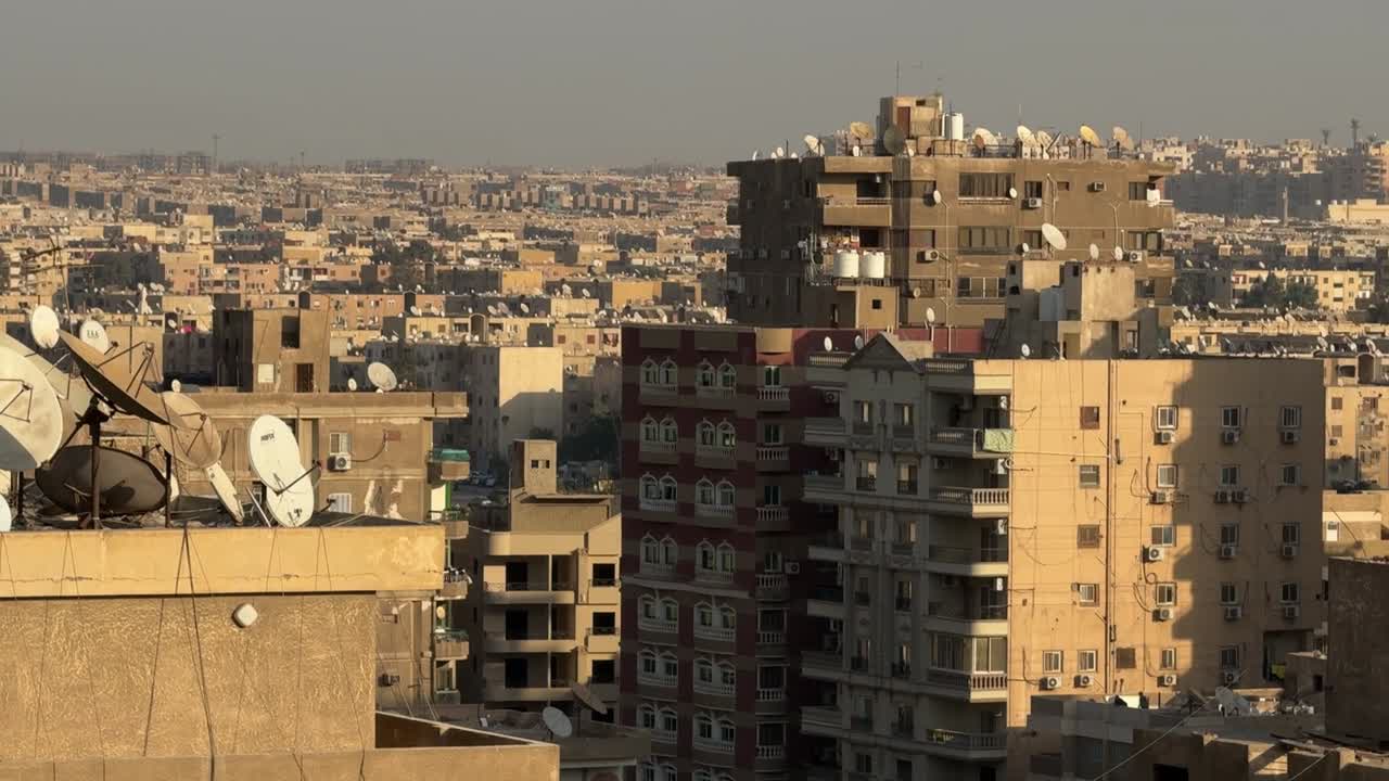 A view of a city from a roof, trucking shot, wide shot
