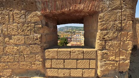 stone structure frames a scenic city view