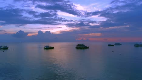 beautiful sunset over the ocean with boats