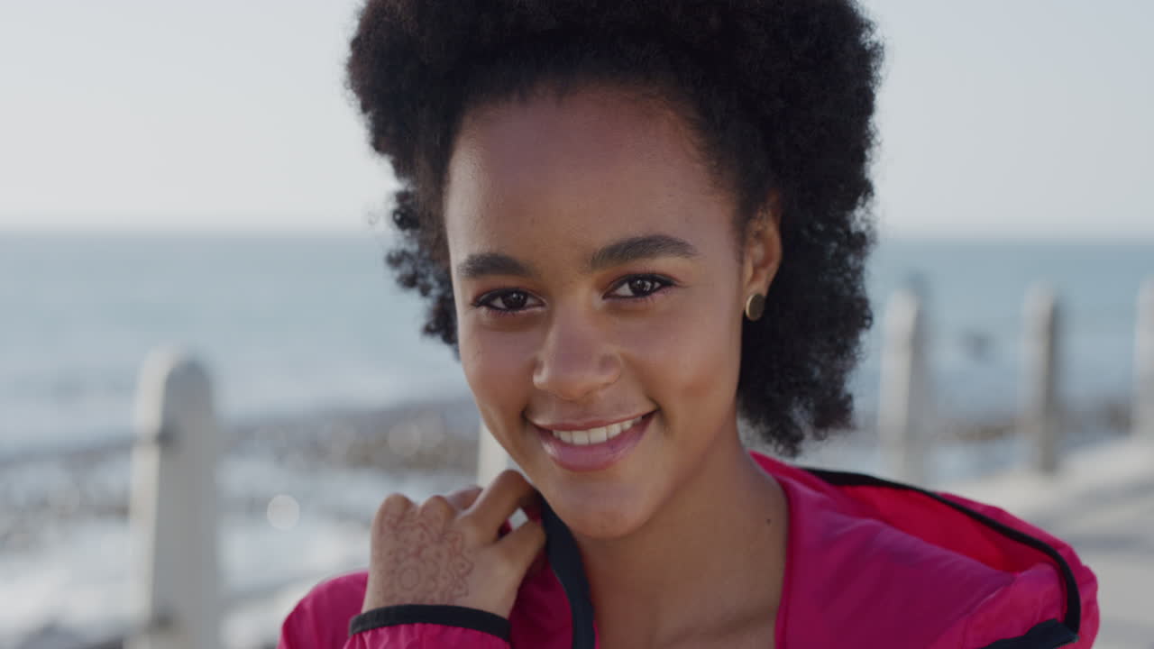 portrait beautiful young african american woman student smiling happy black female looking cute confident girl enjoying relaxed ocean seaside hand henna tattoo