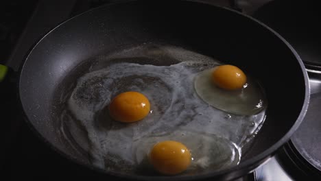 Sprinkled-grated-cheese-over-layered-eggs-shredded-ham-savoury-omelette-in-cast-iron-frying-pan