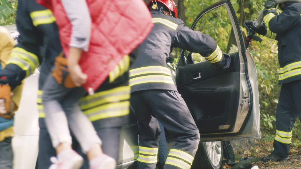 Firefighters Rescuing Children from Car Accident