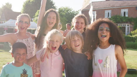 slow motion portrait of excited children at summer garden fete