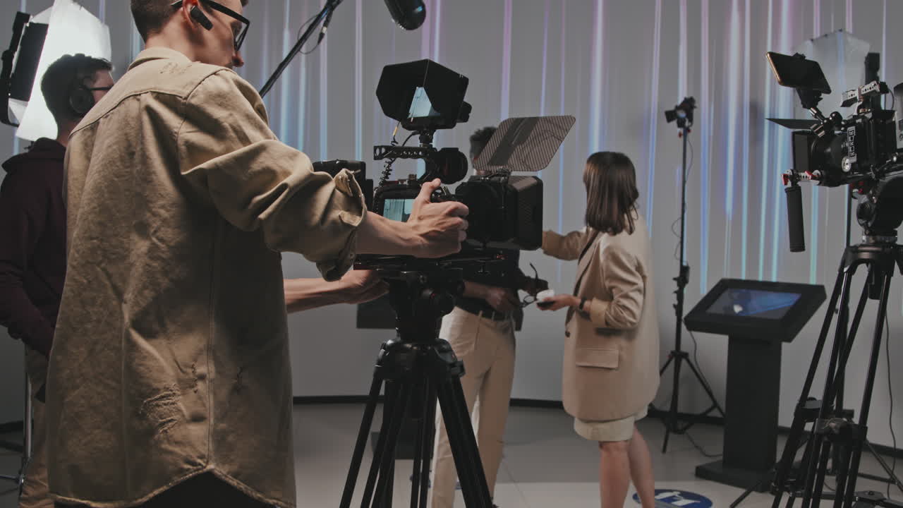 Cameraman With Prosthetic Leg Preparing For Video Shooting In Studio