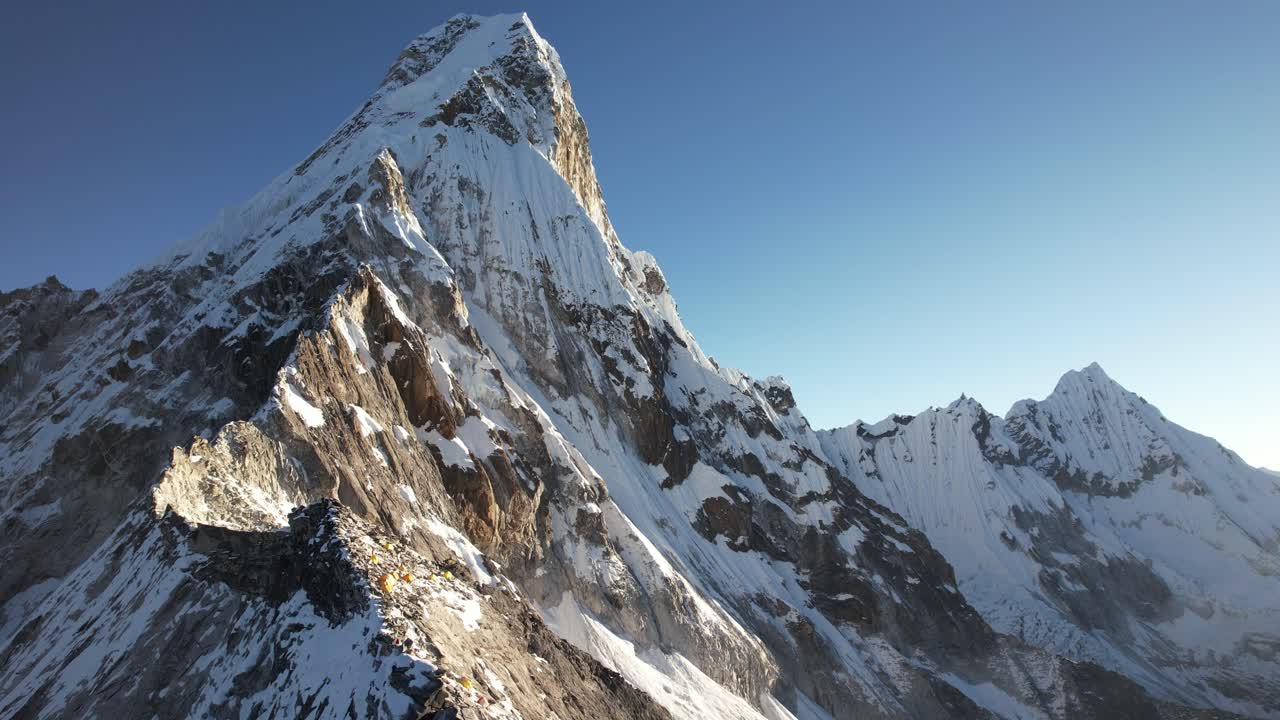 A dramatic drone shot shows the road toward Mount Everest, surrounded by glacier textures and the towering Himalaya. The high-altitude scenery reveals the raw beauty of Nepal’s rugged peaks
