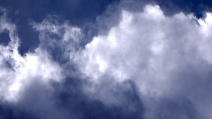 White glowing clouds rolling in the blue sky