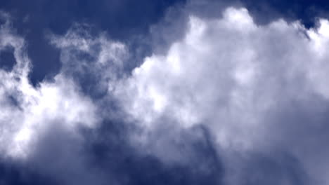 white glowing clouds rolling in the blue sky