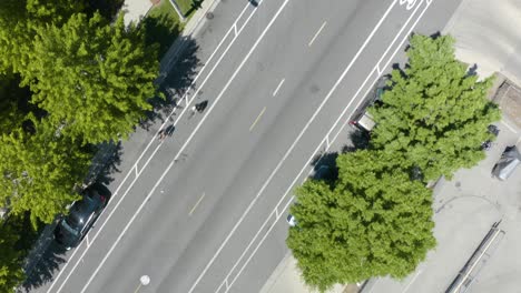 top down view of people cycling on city street in summer