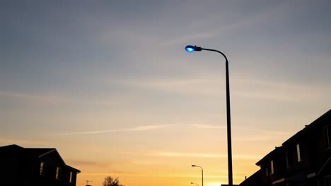 transition from day to night: a captivating journey through silhouetted streets under a beautiful sky with street lamps illuminating the twilight scene