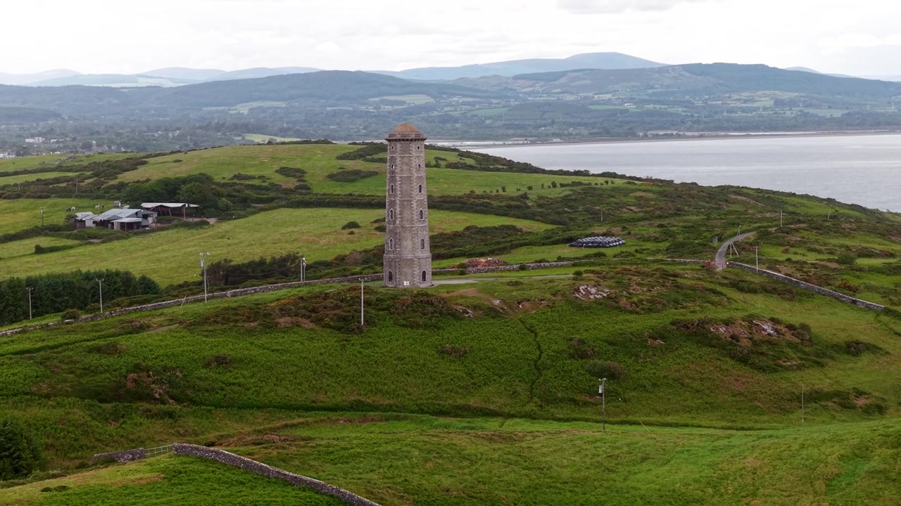 Vecchia torre del faro di Wicklow Head con allontanamento del drone. Paesaggio costiero dell'Irlanda
