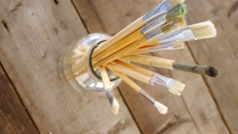 various paintbrush in glass container