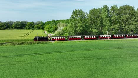 Shot-of-a-steam-train-moves-next-to-a-forest