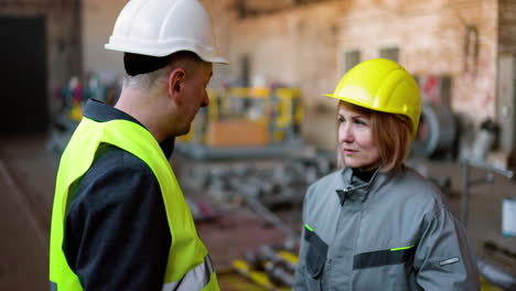 two co-workers talking at work