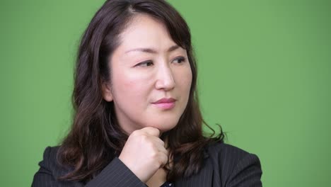 mature stressed asian businesswoman thinking while looking down