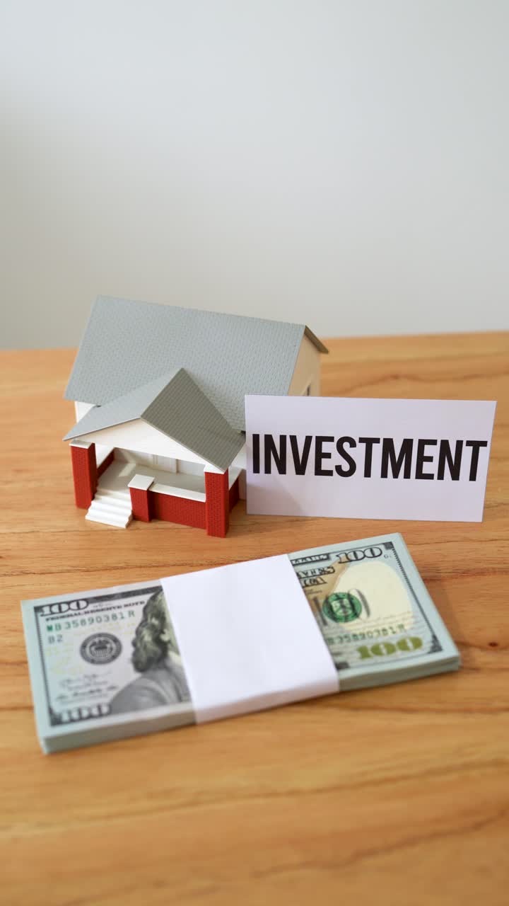 Concept of investing cash in houses and real estate. Secure investment. Vertical shot.