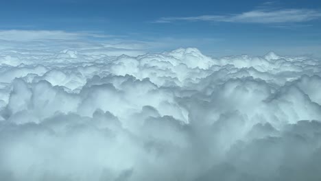 cockpit view overflying a sky overcast with cumulus, daylight