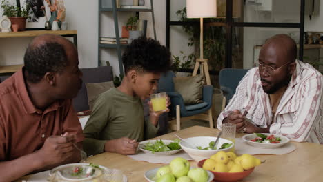 Black-men-and-boy-eating-lunch-at-home