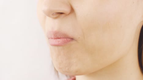 close-up woman eats nuts and dried fruit.