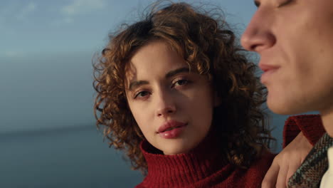 Affectionate-couple-posing-on-beach.-Closeup-young-lovers-looking-sea-view