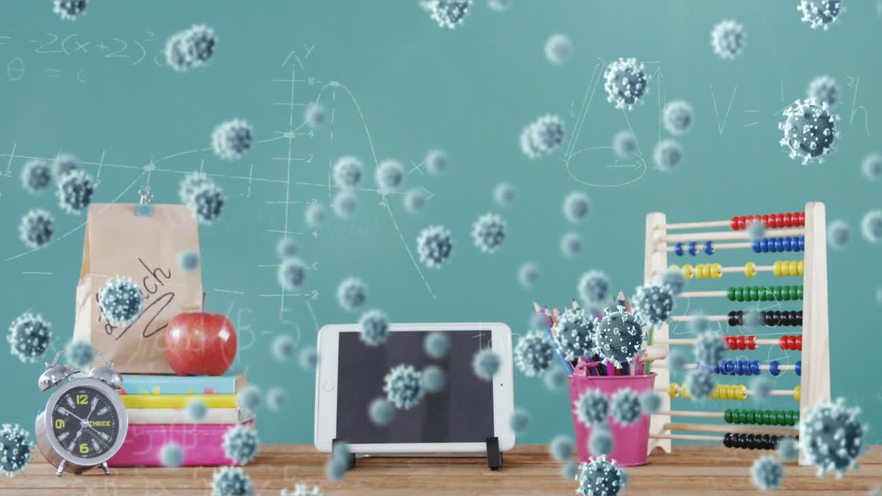 디지털 테이블과 학교 물건 위에 코로나바이러스 세포가 있습니다.