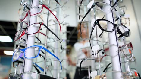 close-up of fashionable eyeglasses in the optical shop. spectacles of different colors and shapes nicely placed on the stand. ophthalmology.