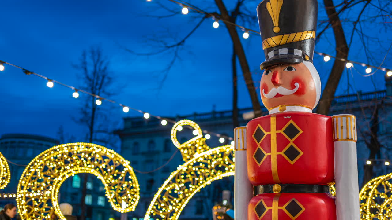 Nutcracker decoration with Christmas lights on the background in the evening