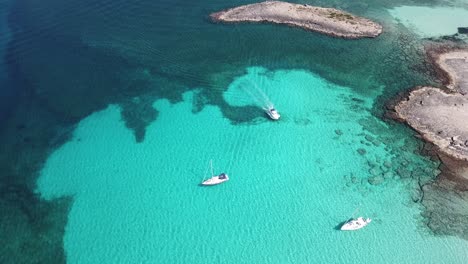 amazing drone aerial landscape of the charming beach es trencs and the boats with a turquoise sea. it has earned the reputation of caribbean beach of mallorca. spain