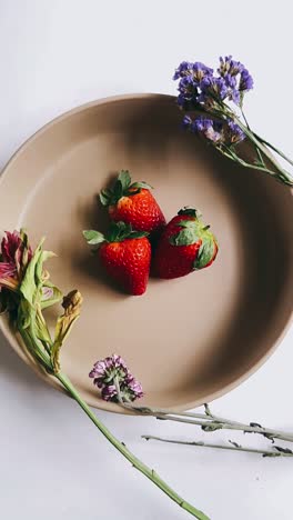 strawberries in a bowl with flowers