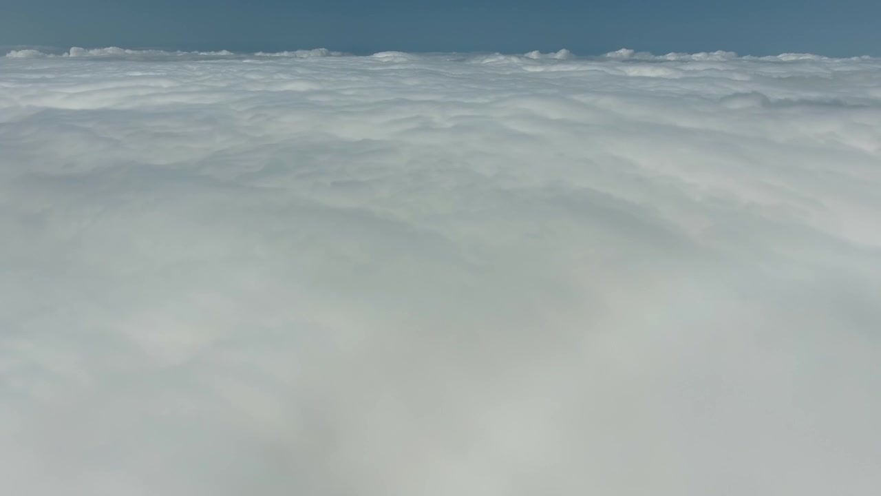 Aerial View of Dense White Clouds Above the Horizon